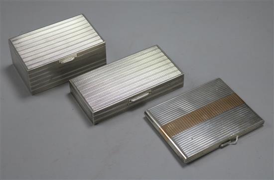 Two engine-turned white metal cigarette boxes (one marked S. L. Silver) and a similar gilt-banded cigarette case,